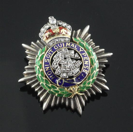 An 18ct gold, diamond and three colour enamel Army Service Corps sweethearts brooch, 33mm.